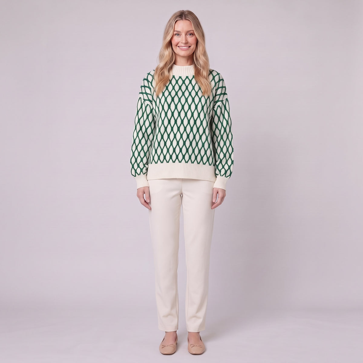 Zinnia lattice knit sweater in cream and emerald green, front view on model