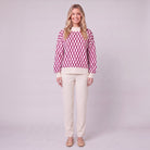 Zinnia lattice knit sweater in cream and fuchsia pink, front view on model